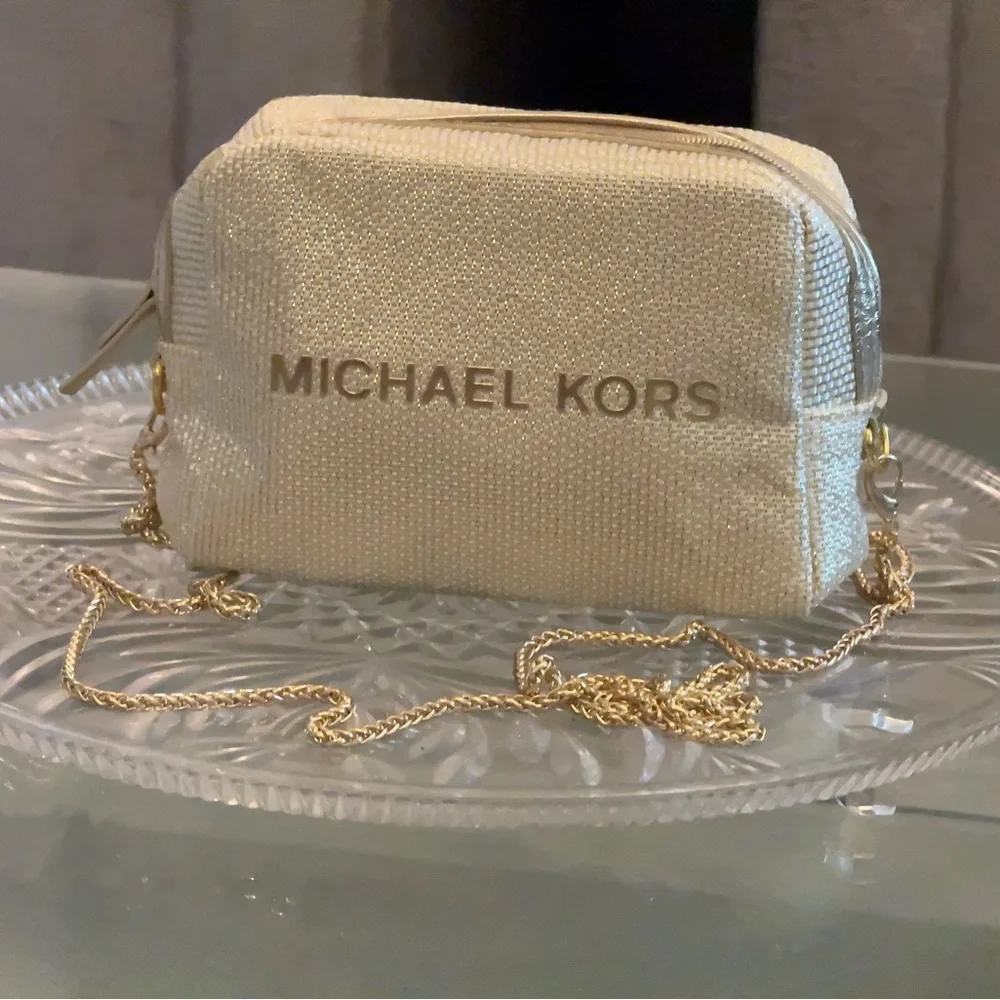 Michael Kors Shimmering Cream Gold Pouch with golden sling